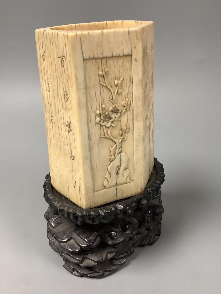 A Chinese inscribed ivory hexagonal brushpot, 17th/18th century, 12.2cm high, replacement wood base panel, age cracks, with associated hardwood stand